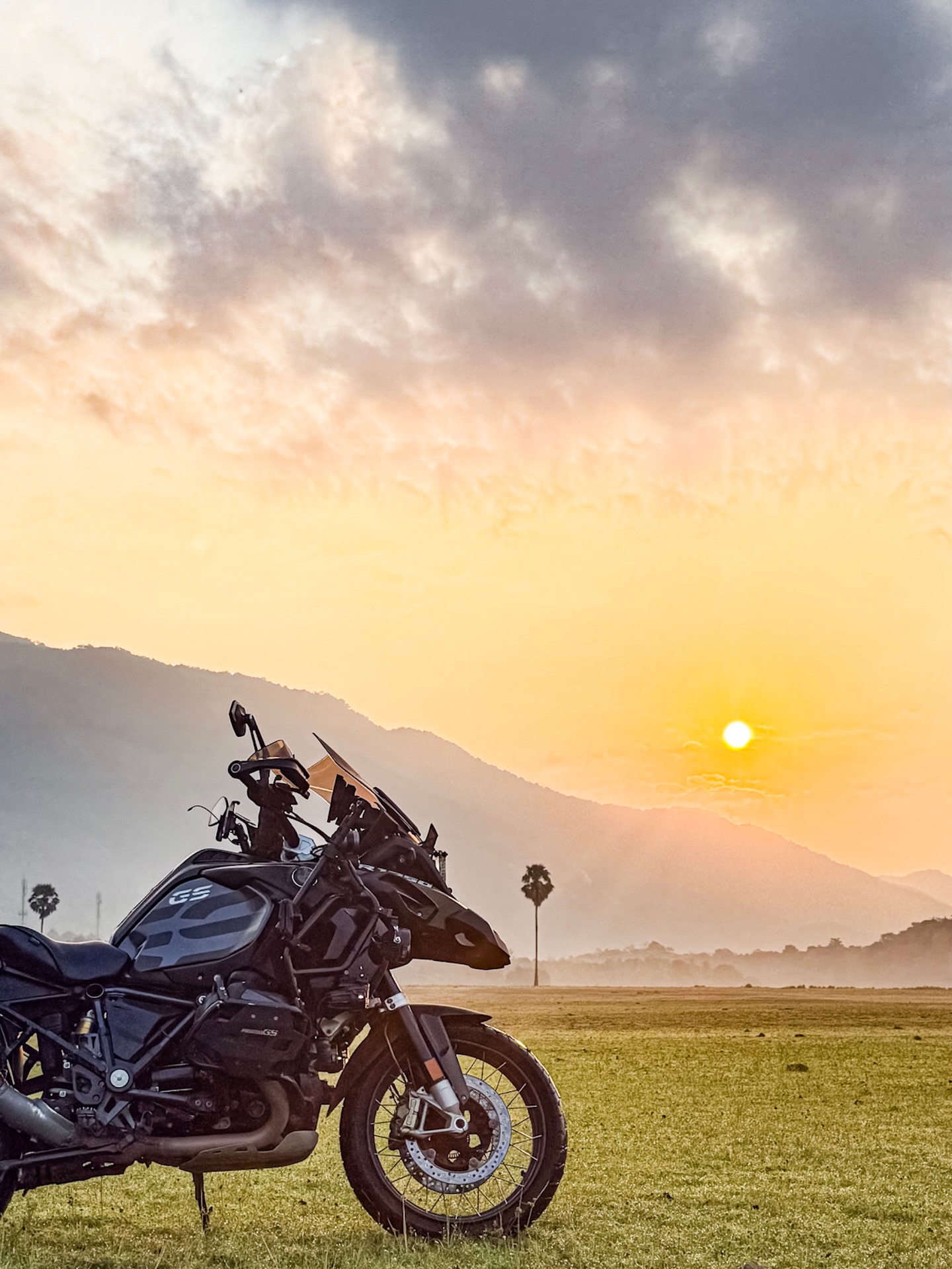 Black Mamba — Arjun's blacked-out R 1250 GS at sunset against the Western Ghats