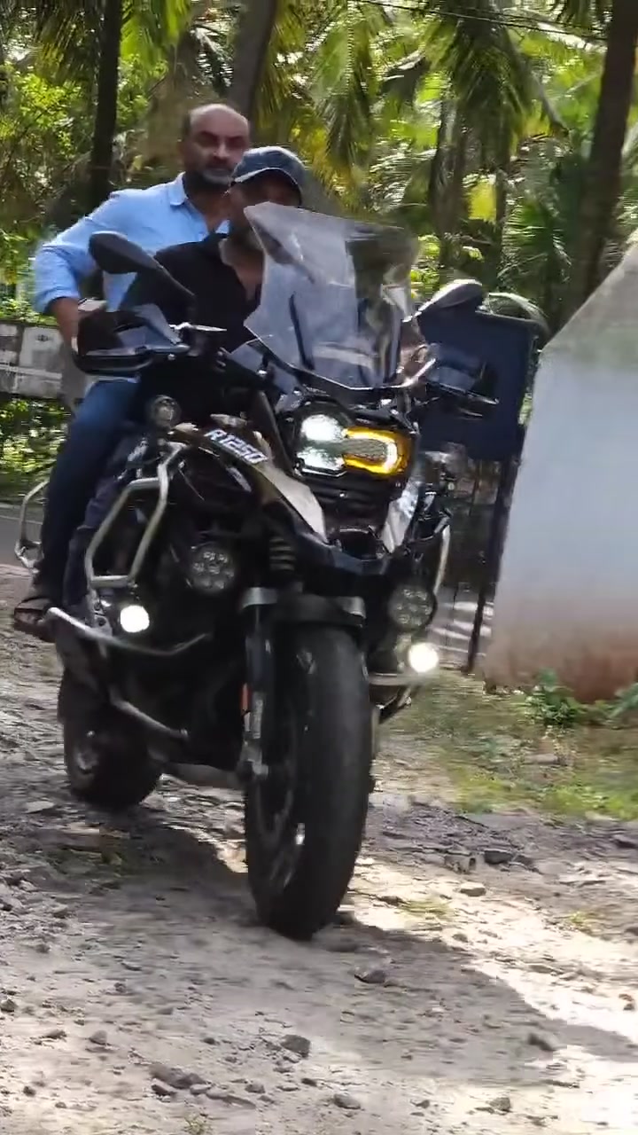 Arjun riding his BMW R 1250 GS through a Kerala village road